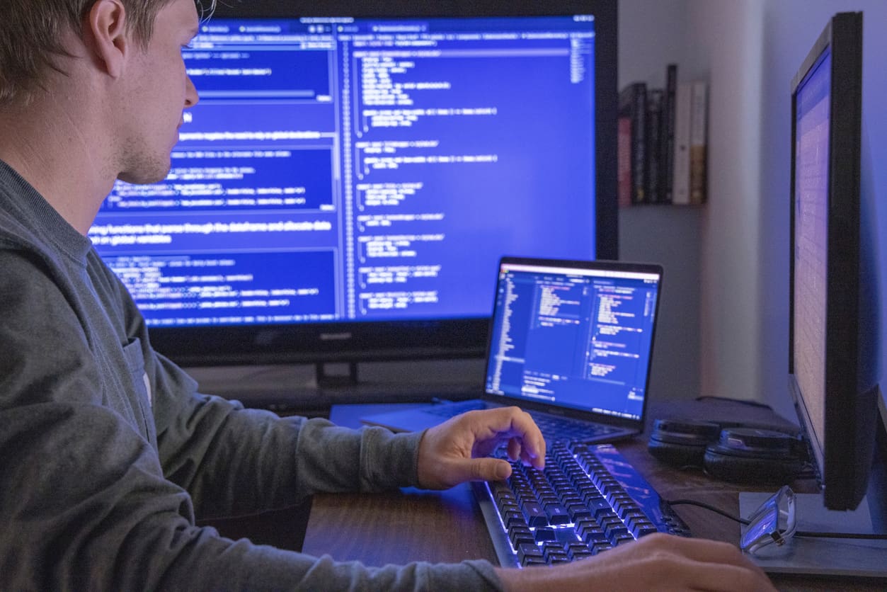 Male IT professional using a computer for software development projects.