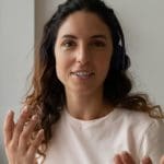 A developer working on a laptop, deciding between JavaScript and TypeScript.