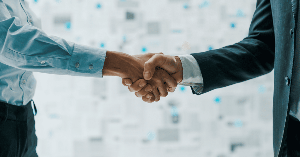 Close-up of a handshake between professionals, symbolizing a trusted collaboration with an outsourced IT provider.