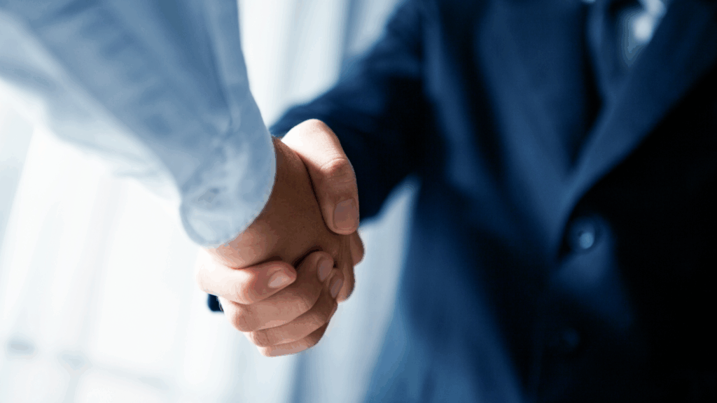 Close-up of professional handshake symbolizing nearshore software outsourcing agreement