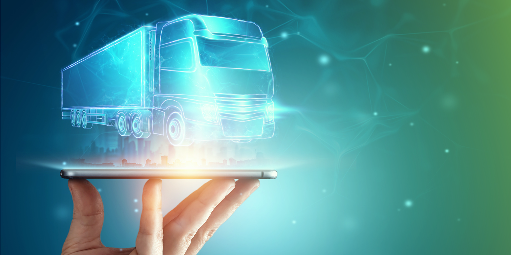 parallelstaff- A hand holds a smartphone, above which a glowing blue hologram of a modern semi-truck appears, symbolizing futuristic technology and digital logistics. The background features abstract blue and green light effects.