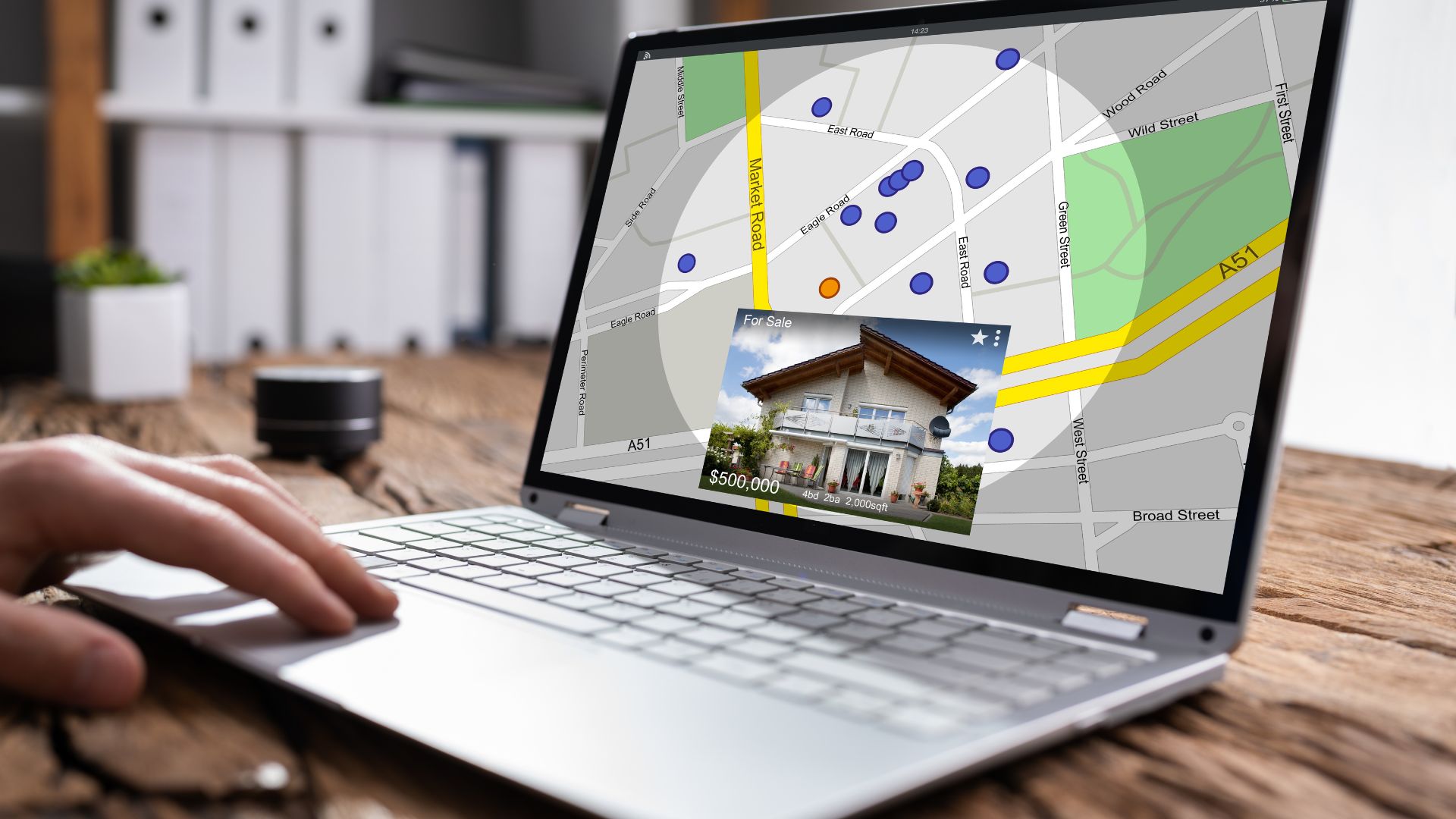 parallelstaff- A person uses a laptop displaying a real estate map with property locations marked and a pop-up image showing a house for sale with a $506,000 price tag.