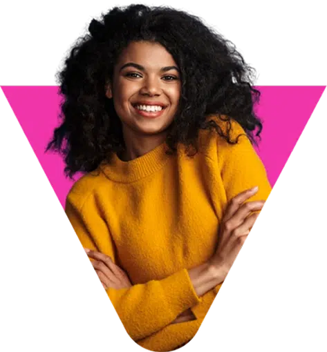 parallelstaff- A smiling woman with curly hair wears a yellow sweater and crosses her arms, standing in front of a bright pink upside-down triangle background.