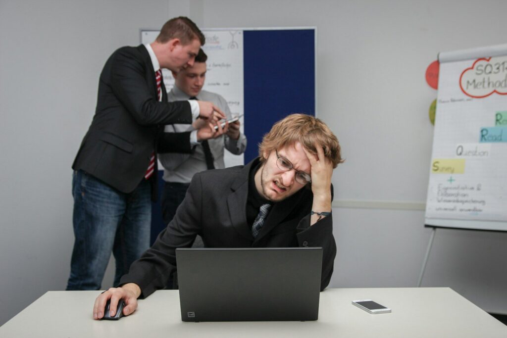 A man sitting in front of a laptop computer