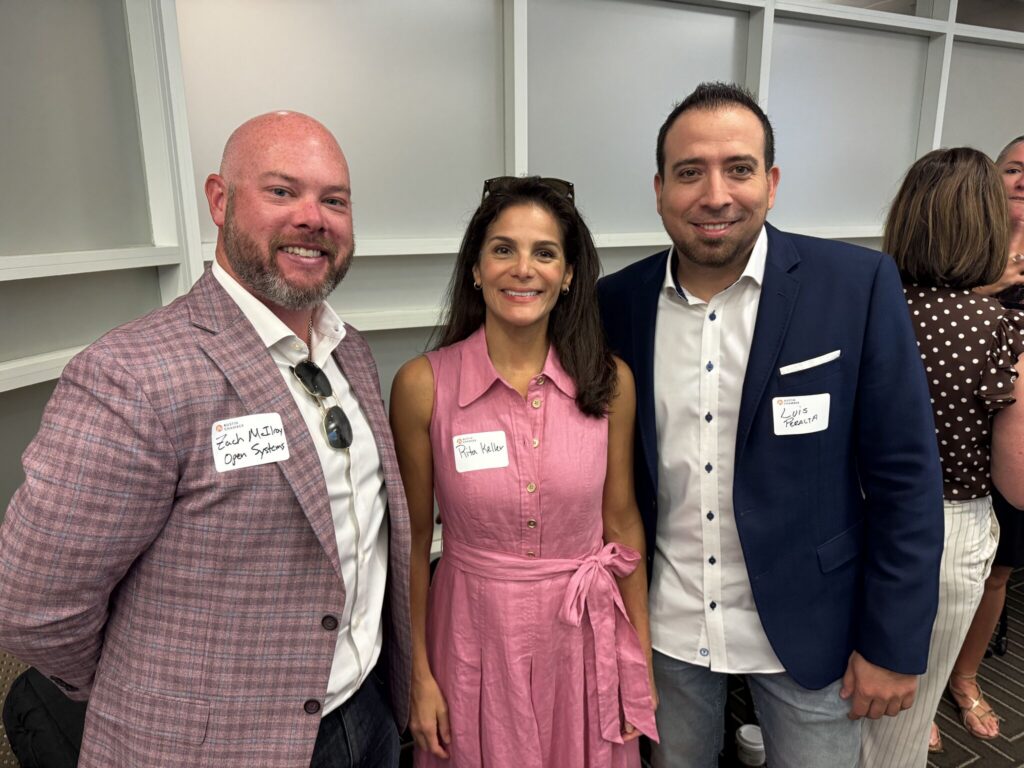 ParallelStaff representatives with an attendee at the Austin Technology Council September Roundtable Breakfast.